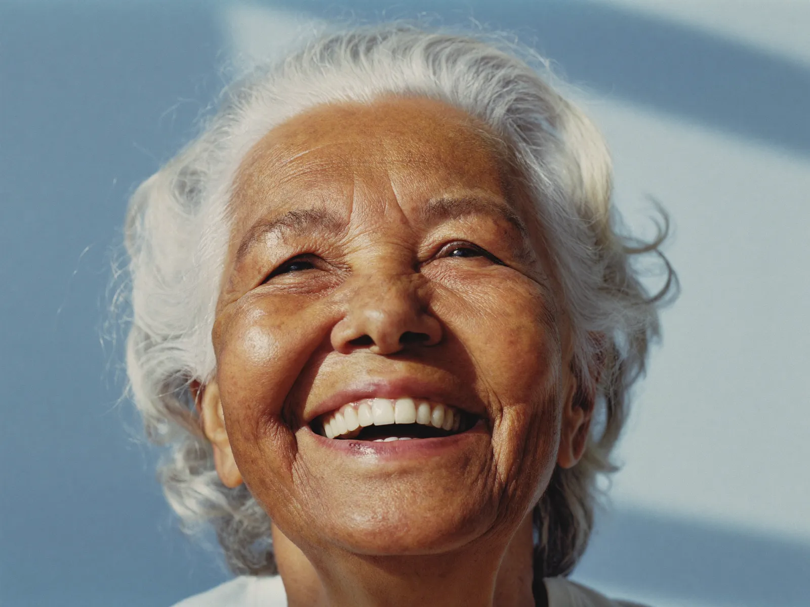 A smiling senior woman with a natural, confident smile