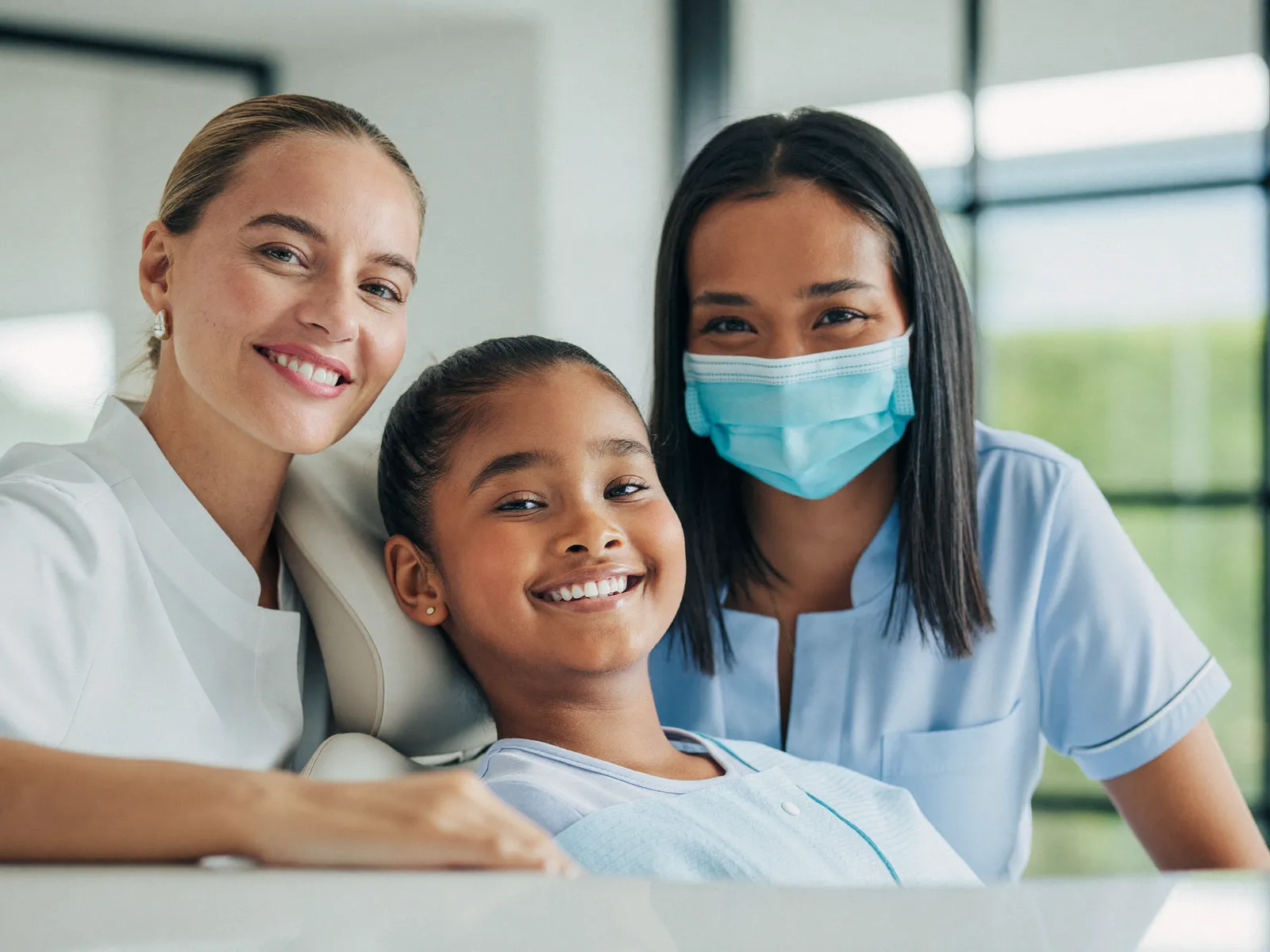 A family smiling together at a dental office