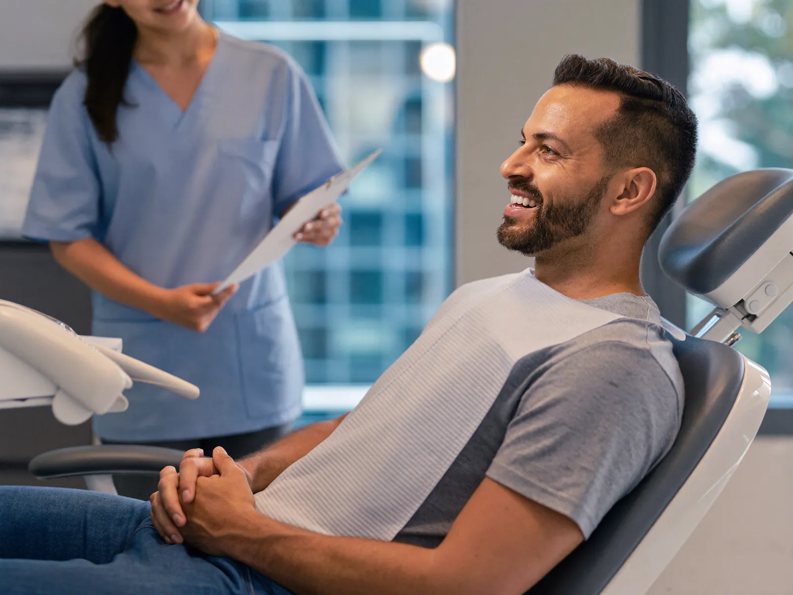 A patient smiling with his dentist during a checkup